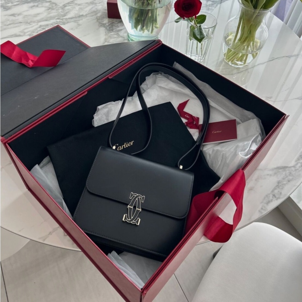 MINI SHOULDER BAG, C DE CARTIER Mini shoulder bag in black calfskin